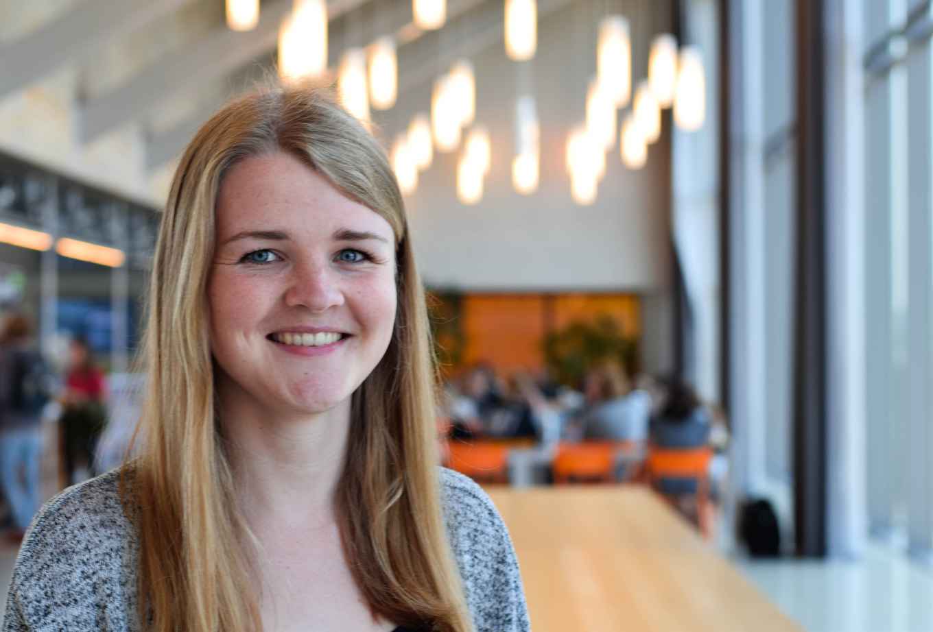 Student with blond hair smiling at camera